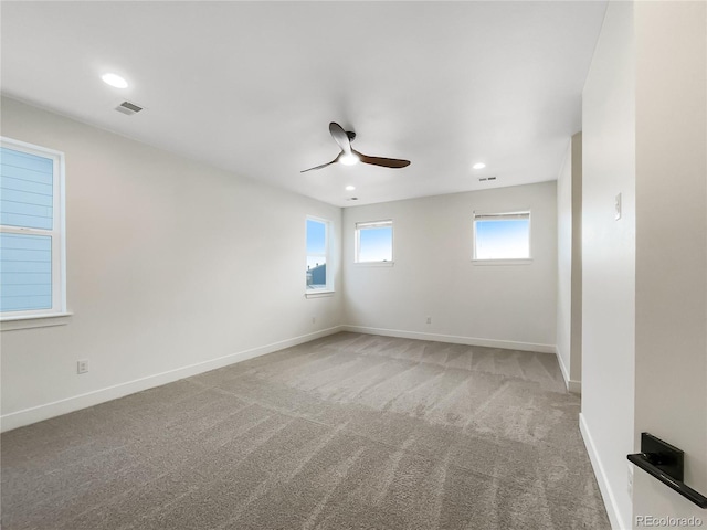 carpeted empty room featuring visible vents, recessed lighting, a ceiling fan, and baseboards