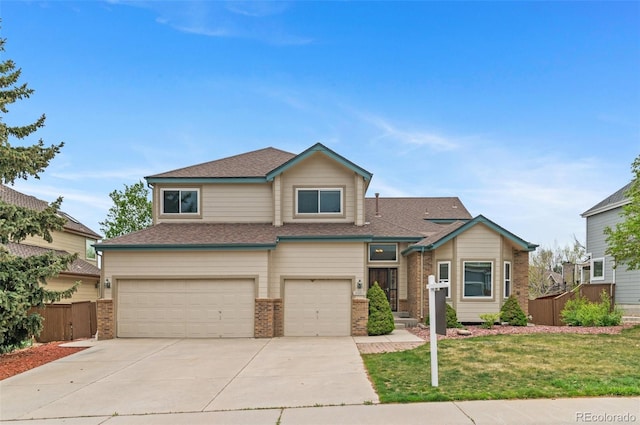 view of front facade with a front lawn, roof with shingles, brick siding, concrete driveway, and an attached garage