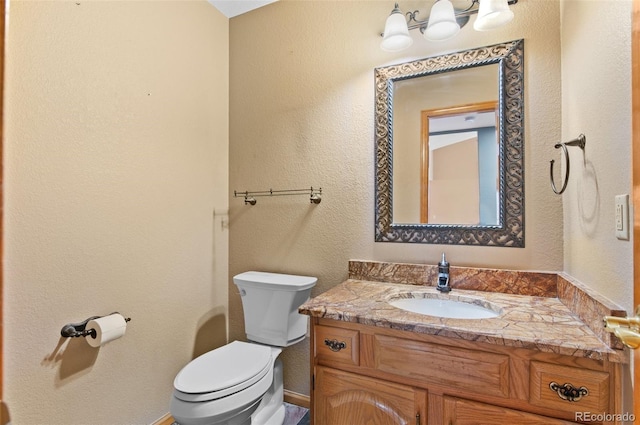 bathroom featuring toilet and vanity