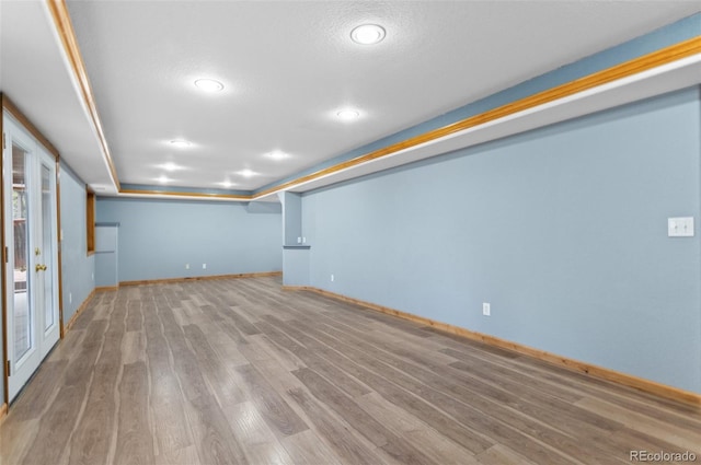 finished basement featuring baseboards, recessed lighting, and wood finished floors