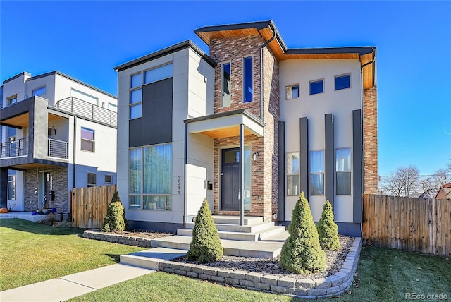 modern home featuring a front yard