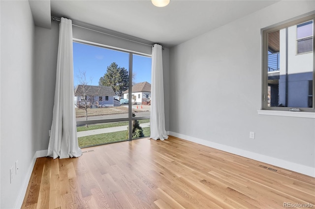 spare room with light hardwood / wood-style flooring