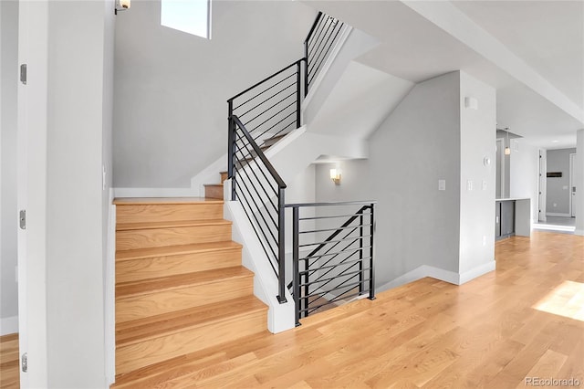 staircase with hardwood / wood-style floors