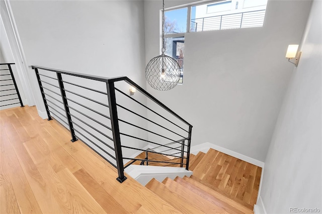 stairs featuring hardwood / wood-style floors