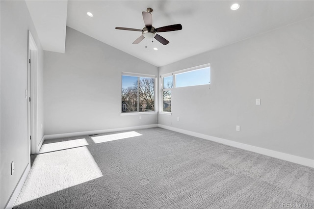 empty room featuring carpet, ceiling fan, and lofted ceiling