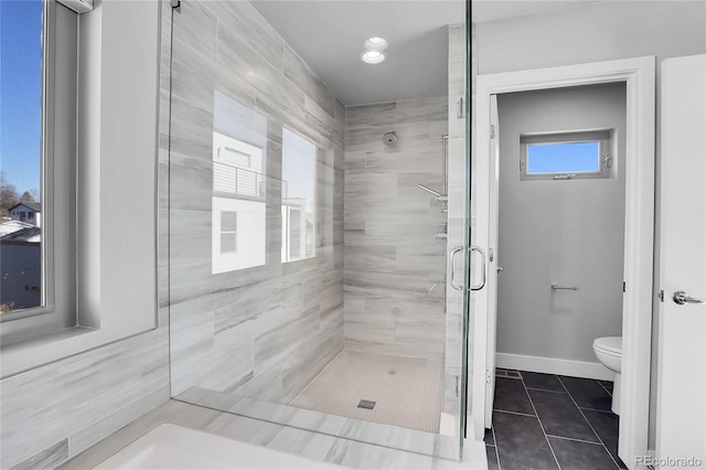 bathroom with tile patterned floors, toilet, and an enclosed shower