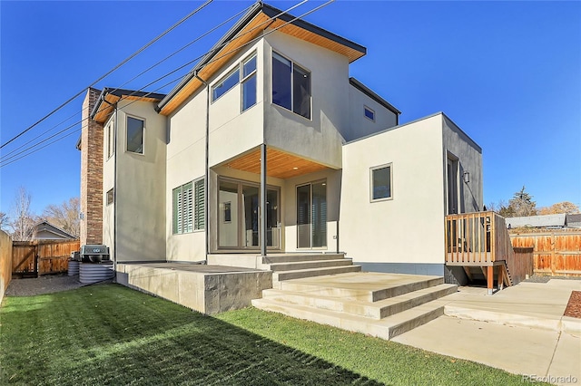 rear view of house with a patio area and a yard