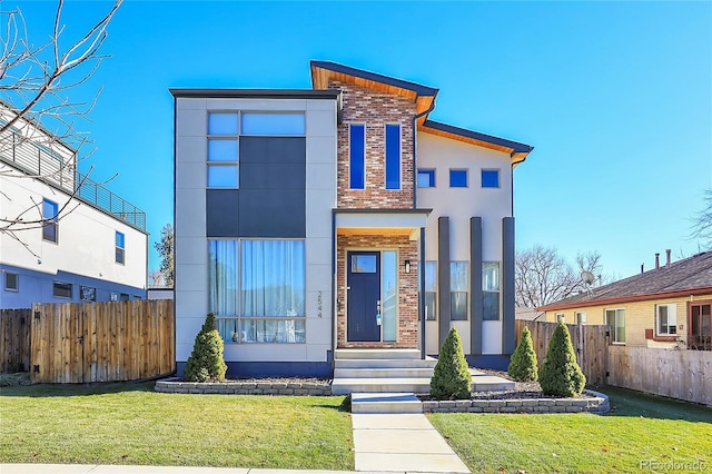 contemporary home with a front lawn