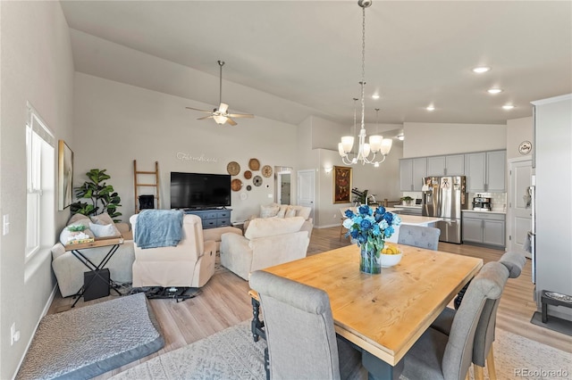 dining room featuring light wood finished floors, recessed lighting, high vaulted ceiling, and ceiling fan with notable chandelier