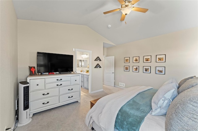 bedroom with visible vents, light carpet, vaulted ceiling, ceiling fan, and ensuite bath