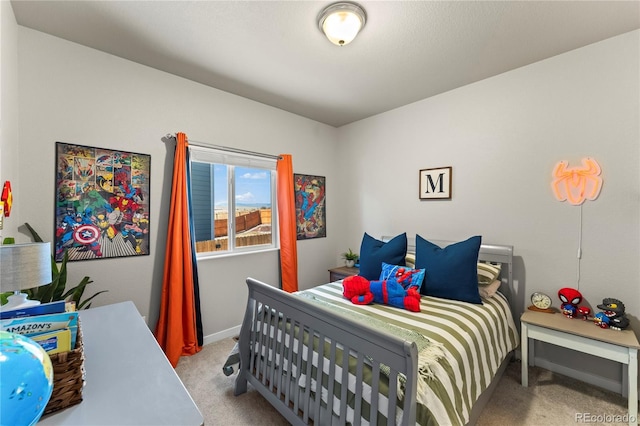 carpeted bedroom featuring baseboards