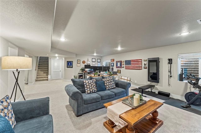 living room with a textured ceiling, stairway, light carpet, and baseboards