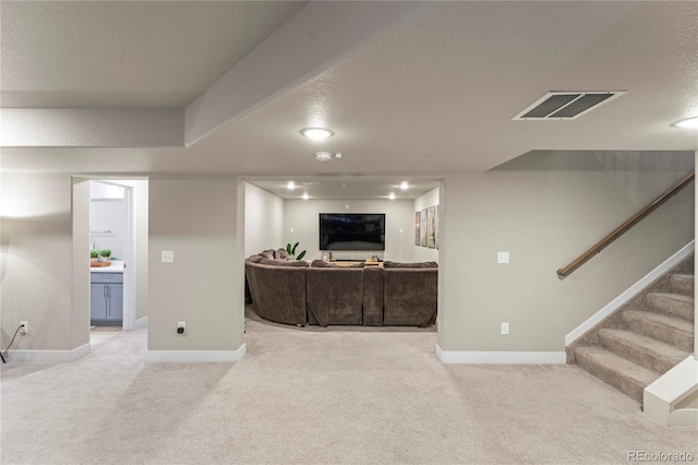 living area featuring stairway, visible vents, light carpet, and baseboards