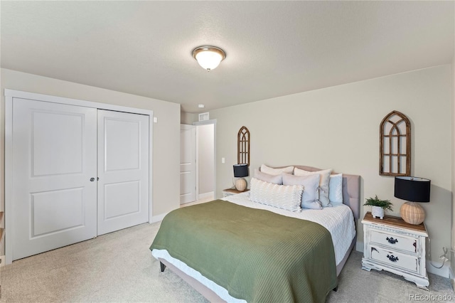 bedroom featuring carpet and a closet