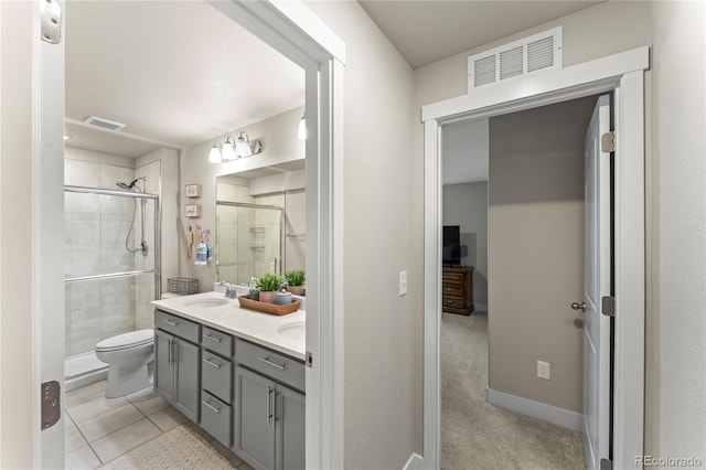 bathroom featuring a stall shower, visible vents, a sink, and double vanity