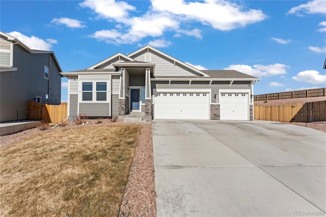 craftsman-style home with a garage, concrete driveway, and fence