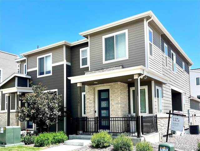 12301 Festival Ln, Thornton, CO 80241 - view of property with stone siding and central AC unit