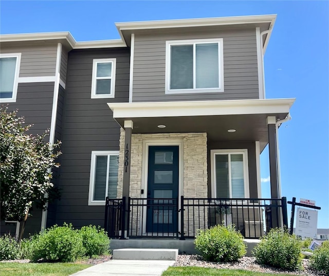 12301 Festival Ln, Thornton, CO 80241 - view of front of property with a porch and stone siding