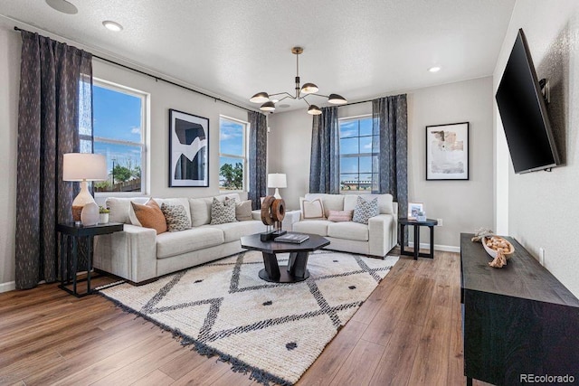 2118 Wagon Wheel Aly, Brighton, CO 80601 - living room with a chandelier, wood finished floors, and recessed lighting