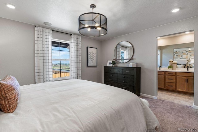 2118 Wagon Wheel Aly, Brighton, CO 80601 - bedroom featuring light carpet, a chandelier, connected bathroom, a textured ceiling, and recessed lighting