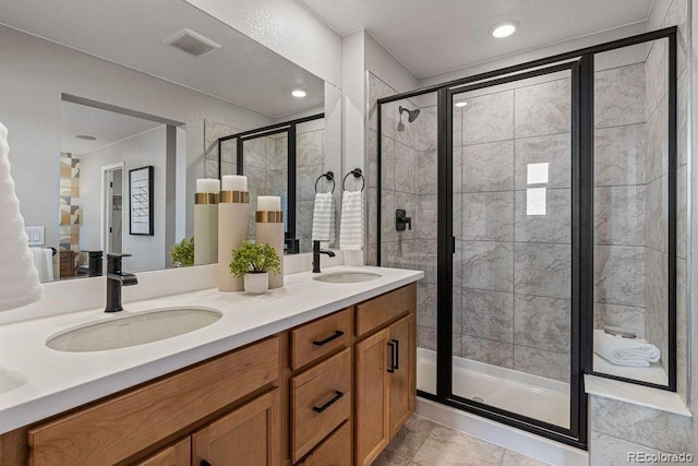 2118 Wagon Wheel Aly, Brighton, CO 80601 - bathroom featuring a stall shower, double vanity, and tile patterned flooring