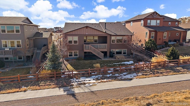 exterior space with a fenced front yard, a residential view, and stairs