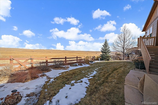 view of yard featuring fence and a rural view