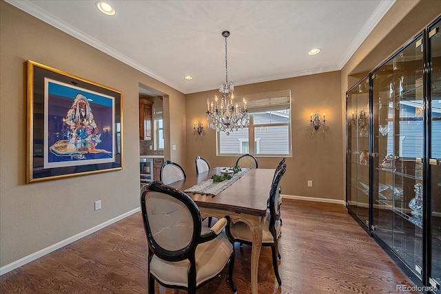 dining room featuring dark wood-style flooring, a notable chandelier, ornamental molding, beverage cooler, and baseboards