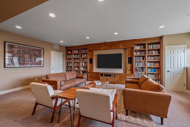 carpeted living room featuring built in shelves