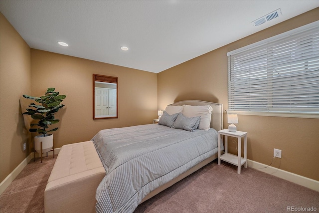 carpeted bedroom with baseboards, visible vents, and recessed lighting