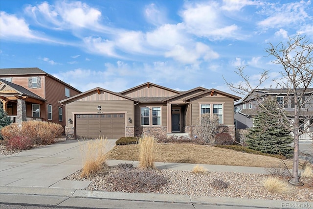 craftsman inspired home featuring a garage, stone siding, board and batten siding, and concrete driveway