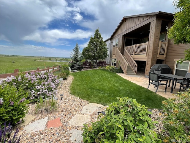 view of yard with a patio and stairway