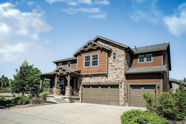 9607 Williamsburg St, Littleton, CO 80125 - craftsman-style home featuring stone siding, a garage, covered porch, and concrete driveway