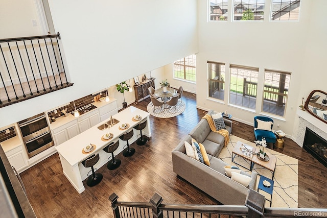 9607 Williamsburg St, Littleton, CO 80125 - living room with a towering ceiling, dark wood-type flooring, and a fireplace