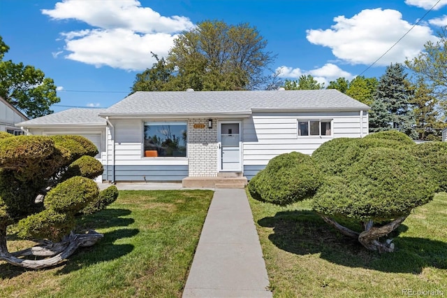 1211 S Zuni St, Denver, CO 80223 - view of front of house with a front lawn, an attached garage, and a shingled roof