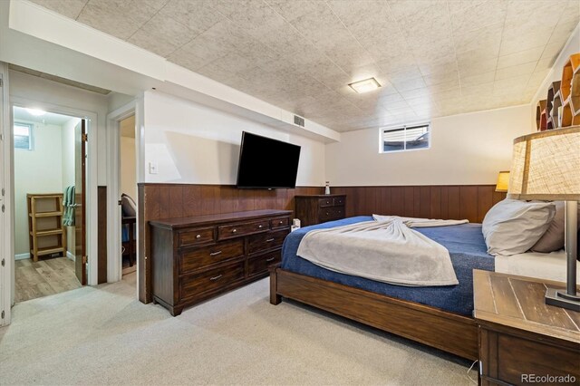 1211 S Zuni St, Denver, CO 80223 - bedroom featuring light colored carpet, wainscoting, and wooden walls
