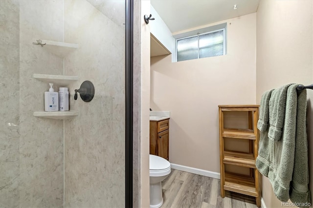 1211 S Zuni St, Denver, CO 80223 - full bathroom featuring wood finished floors, a shower stall, vanity, and toilet
