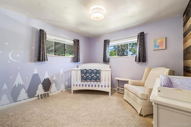 1211 S Zuni St, Denver, CO 80223 - carpeted bedroom featuring a crib and baseboards