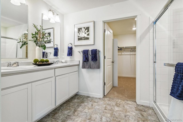 27756 E Byers Pl, Aurora, CO 80018 - bathroom with a shower stall, a walk in closet, double vanity, and baseboards