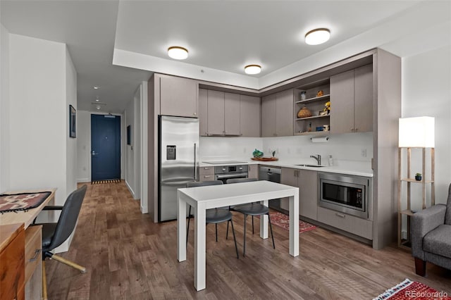 1750 Wewatta St Unit 605, Denver, CO 80202 - kitchen with stainless steel appliances, open shelves, a sink, gray cabinets, and dark wood-style floors
