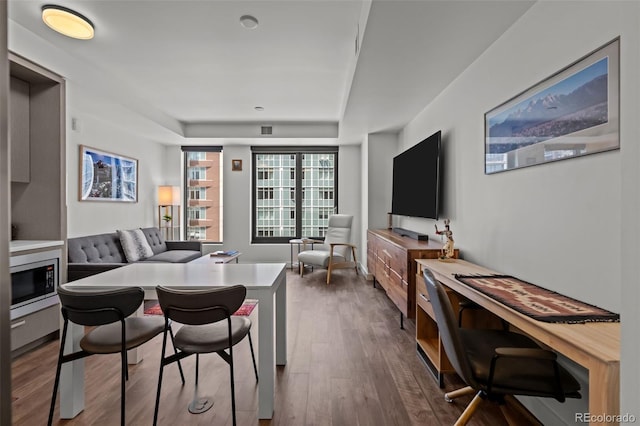 1750 Wewatta St Unit 605, Denver, CO 80202 - dining area featuring dark wood-style flooring and a raised ceiling