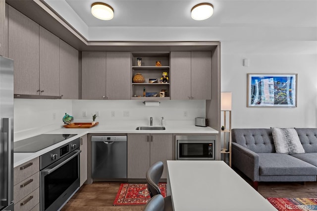 1750 Wewatta St Unit 605, Denver, CO 80202 - kitchen with stainless steel appliances, dark wood-type flooring, light countertops, and a sink