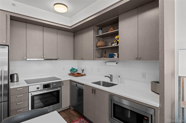 1750 Wewatta St Unit 605, Denver, CO 80202 - kitchen with appliances with stainless steel finishes, a sink, dark wood-style floors, and light countertops
