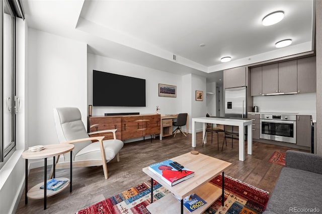 1750 Wewatta St Unit 605, Denver, CO 80202 - living area featuring dark wood finished floors and baseboards