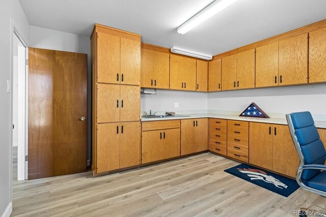 1903 Northmoor Ter, Pueblo, CO 81008 - kitchen with light countertops, light wood-type flooring, and a sink