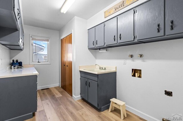1903 Northmoor Ter, Pueblo, CO 81008 - laundry area with cabinet space, electric dryer hookup, light wood finished floors, baseboards, and hookup for a washing machine