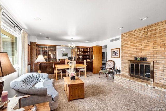 1903 Northmoor Ter, Pueblo, CO 81008 - living room with a chandelier, carpet floors, a fireplace, and recessed lighting