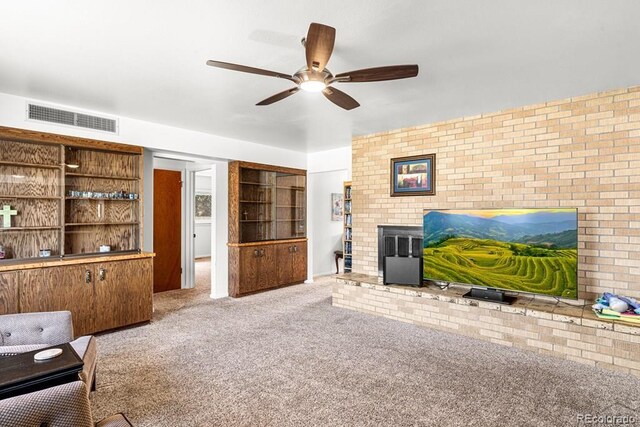 1903 Northmoor Ter, Pueblo, CO 81008 - living room featuring a ceiling fan, carpet flooring, a fireplace, and brick wall