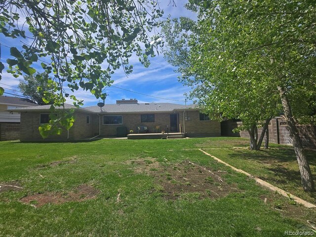 1903 Northmoor Ter, Pueblo, CO 81008 - rear view of house with a yard and brick siding