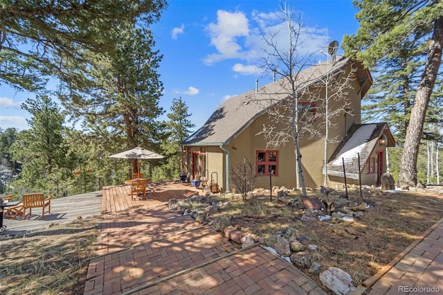 174 Needle Creek Rd, Divide, CO 80814 - view of side of home with stucco siding, a wooden deck, and a patio area